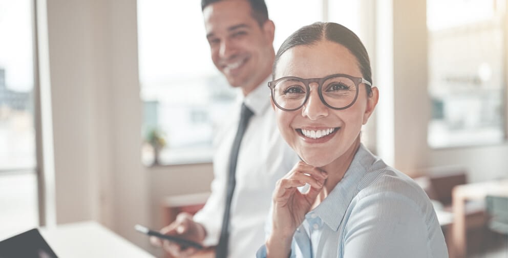 Business partners smiling because accounts receivable factoring helped their business